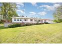 Charming single-story home featuring a metal roof, white siding, and well-maintained lawn at 545 Billy Fitts Rd, Siler City, NC 27344