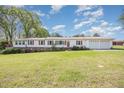 Charming home with a metal roof, white siding, attached garage, and green lawn at 545 Billy Fitts Rd, Siler City, NC 27344