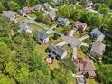 Aerial view of a neighborhood with lush greenery and well-maintained homes, offering a glimpse of community living at 5708 Butter Churn Way, Fuquay Varina, NC 27526