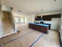 Open-concept kitchen with a large island, dark cabinets, and eat in area at 59 Grove Township Way, Angier, NC 27501
