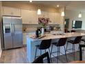 Modern kitchen with white cabinetry, granite countertops, and stainless steel appliances at 59 Grove Township Way, Angier, NC 27501