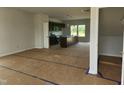 Open kitchen featuring dark cabinets, a spacious island, and modern lighting at 59 Grove Township Way, Angier, NC 27501