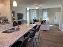 Open concept living room with large kitchen island and seating at 59 Grove Township Way, Angier, NC 27501