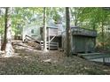 Multi-level deck and stairs leading to the yard surrounded by trees in a private, wooded setting at 6409 Lakeland Dr, Raleigh, NC 27612