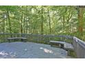 Spacious outdoor deck with built-in benches surrounded by lush trees, perfect for relaxation at 6409 Lakeland Dr, Raleigh, NC 27612