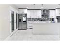 Bright, all-white kitchen featuring stainless steel appliances and a center island at 6409 Lakeland Dr, Raleigh, NC 27612
