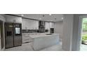Modern kitchen featuring white cabinets, stainless steel appliances, and an island at 6409 Lakeland Dr, Raleigh, NC 27612