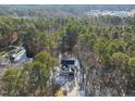An aerial view shows the surrounding lush tree line and neighborhood at 7218 Sunrise Rd, Chapel Hill, NC 27514