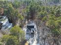 An aerial view shows the beautiful home site surrounded by a dense tree line at 7218 Sunrise Rd, Chapel Hill, NC 27514