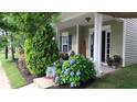 Inviting front porch features classic columns and beautiful landscaping, creating a warm welcome at 742 Keystone Park Dr, Morrisville, NC 27560