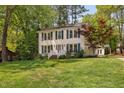 Attractive two-story home featuring a well-kept lawn, and an outbuilding adding convenience and character at 7433 Deer Track Dr, Raleigh, NC 27613