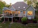 Back of home featuring a large screened porch, deck, and view of the backyard at 8480 Falkirk Ridge Ct, Wake Forest, NC 27587