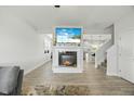 Bright living room featuring a modern fireplace and open floor plan with gray flooring at 85 Sun Mdw Cir, Benson, NC 27504