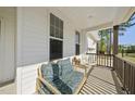 Cozy front porch seating area featuring comfortable pillows, accent chairs, and a charming view at 8812 Green Arbor Ct, Wake Forest, NC 27587