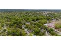 Areal view of cozy community surrounded by mature trees and neighborhood stores at 905 David St, Henderson, NC 27536