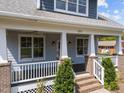 Classic front porch with sturdy columns, white railings, and a cozy ambiance at 1011 Parker St, Raleigh, NC 27607