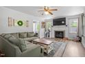 Inviting living room showcasing a fireplace, large windows, and comfortable seating area at 1017 Southerlund Rd, Garner, NC 27529