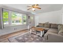 Bright living room with large windows, stylish decor, a cozy sectional sofa and lots of natural light at 1017 Southerlund Rd, Garner, NC 27529