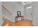Bright entryway featuring hardwood floors, staircase, and a classic, neutral color palette at 109 Jones Creek Pl, Chapel Hill, NC 27516