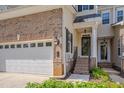 Inviting front entrance of a townhome with brick accents and a well-manicured landscape at 109 Jones Creek Pl, Chapel Hill, NC 27516