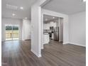 Bright and spacious living room open to kitchen featuring stylish wood-look flooring at 11430 International Dr, Middlesex, NC 27557