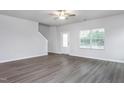 Open-concept living room featuring luxury vinyl plank flooring and natural light at 11450 International Dr, Middlesex, NC 27557