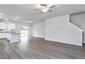 Spacious open concept living area showcasing new vinyl plank flooring, an island, and a staircase at 11450 International Dr, Middlesex, NC 27557