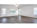Bright living room with ample natural light and luxury vinyl plank flooring at 11450 International Dr, Middlesex, NC 27557