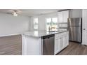 Stylish kitchen with stainless steel appliances, granite countertops, and an island featuring a sink and dishwasher at 11682 International Dr, Middlesex, NC 27557