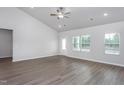 Bright living room with vaulted ceilings, laminate wood flooring, and natural light from multiple windows at 11740 International Dr, Middlesex, NC 27557