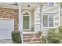 Welcoming front entrance with a decorative wreath and neatly landscaped bushes at 1201 Bellenden Dr, Durham, NC 27713