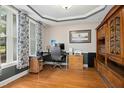 Stylish office features hardwood floors, custom built-ins, a large window, and neutral paint at 1503 Anterra Dr, Wake Forest, NC 27587