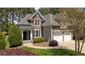 An attractive stone home with manicured landscaping and a two-car attached garage at 1545 Heritage Links Dr, Wake Forest, NC 27587