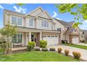 Attractive two-story home with vinyl siding, brick accents, well-kept lawn and a two-car garage at 1919 Sinclair Trce, Burlington, NC 27215