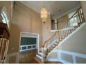 Grand foyer featuring staircase, chandelier, and elegant trim details at 208 E Jules Verne Way, Cary, NC 27511