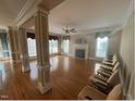 Spacious living room with hardwood floors, fireplace, and large windows at 208 E Jules Verne Way, Cary, NC 27511