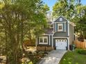 Charming two-story home with blue siding, white trim, flower boxes and a well-manicured front yard at 209 Dickens Dr, Raleigh, NC 27610