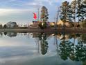 Scenic view of houses reflecting on a pond surrounded by trees at 240 Liberty Star Rd, Wendell, NC 27591