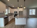 Modern kitchen featuring white cabinets, granite countertops, and stainless steel appliances at 244 Bluejay St, Clayton, NC 27520