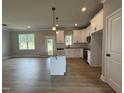 Bright kitchen boasts stainless appliances, granite countertops and an island at 244 Bluejay St, Clayton, NC 27520