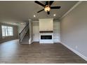 Cozy living room featuring a fireplace, built-in shelving, and hardwood floors at 244 Bluejay St, Clayton, NC 27520