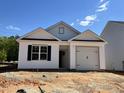 New construction home with white siding and black trim, a single car garage, and front yard with newly placed dirt at 250 Bluejay St, Clayton, NC 27520