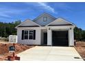 New construction with white siding, black shutters, and an attached garage, all under a bright blue sky at 250 Bluejay St, Clayton, NC 27520