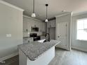 Bright kitchen with a center island, stainless steel appliances and a modern design at 250 Bluejay St, Clayton, NC 27520