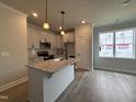 Bright kitchen features granite countertops, stainless steel appliances, and a center island at 250 Bluejay St, Clayton, NC 27520
