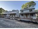 New construction homes showcasing modern design with charming porches and brick foundation details at 2654 Lawndale, Durham, NC 27705
