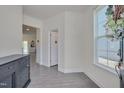 Bright foyer with gray wood flooring, a console table, and views into other rooms at 3011 Ginger Hill Ln, Durham, NC 27703