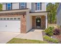 Close-up view of a home's entryway, showcasing a brick facade and welcoming front door at 3011 Ginger Hill Ln, Durham, NC 27703