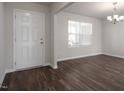 Bright living room features wood floors, neutral walls, and a charming chandelier at 302 Shiloh Way, Mebane, NC 27302