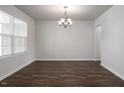 Open room design featuring wood floors, neutral paint, and classic chandelier at 302 Shiloh Way, Mebane, NC 27302